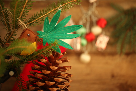 handmade toy on the Christmas tree. cannabis leaf in the bird's beak. Cannabis marijuana new year entertainmentの写真素材