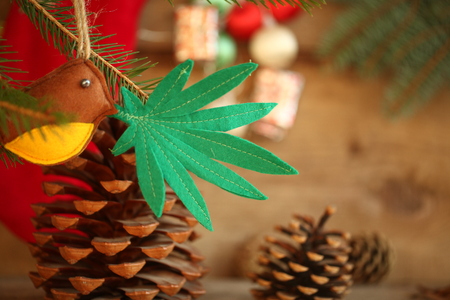 handmade toy on the Christmas tree. cannabis leaf in the bird's beak. Cannabis marijuana new year entertainmentの写真素材
