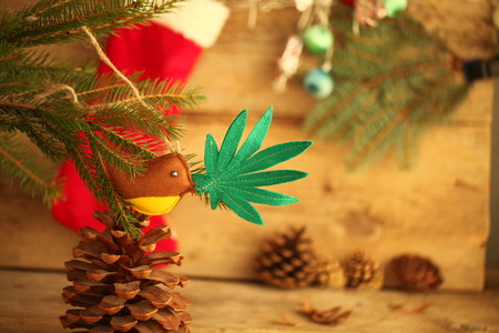 handmade toy on the Christmas tree. cannabis leaf in the bird's beak. Cannabis marijuana new year entertainmentの写真素材