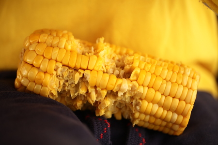 Boy eating sweet corn
