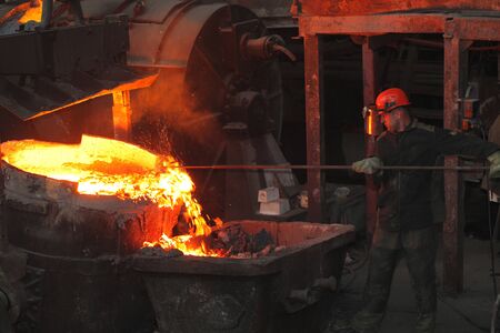 Belarus, Minsk, 2014. Work in the foundry. molten metal worker at a metallurgical plantのeditorial素材