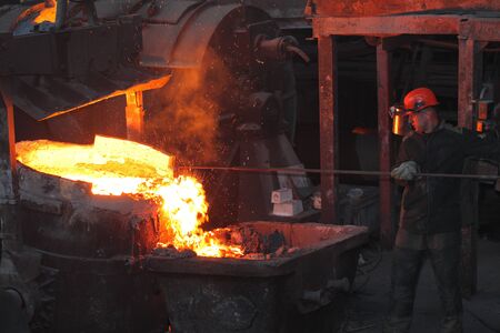 Belarus, Minsk, 2014. Work in the foundry. molten metal worker at a metallurgical plantのeditorial素材