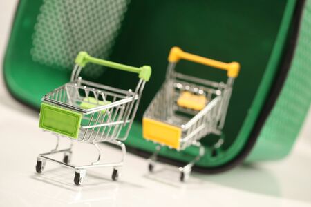 Green plastic shopping basket with black handles.の写真素材