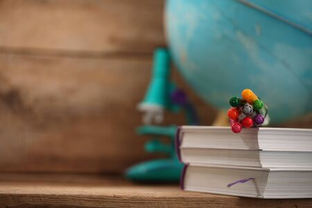 Concert education globe books microscope and pencils on background.