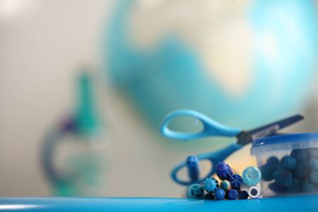 Concert education globe books microscope and pencils on background.