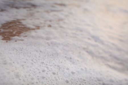 white foam on sandy tropical ocean beachの写真素材