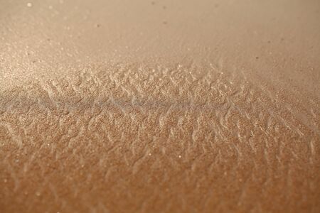 white foam on sandy tropical ocean beachの写真素材