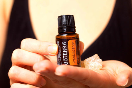 belarus, minsk, 2021. illustrative editorial doterra oil in hand womanのeditorial素材