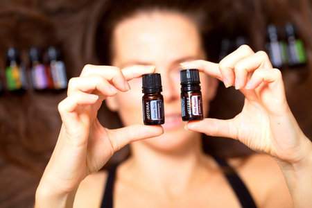 belarus, minsk, 2021. illustrative editorial doterra oil in hand womanのeditorial素材