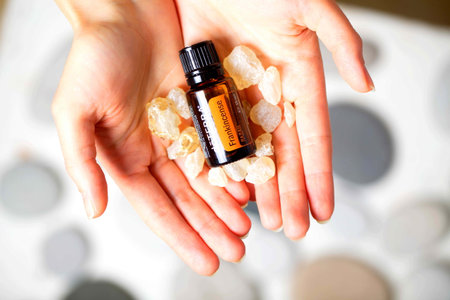 belarus, minsk, 2021. illustrative editorial doterra oil in hand womanのeditorial素材