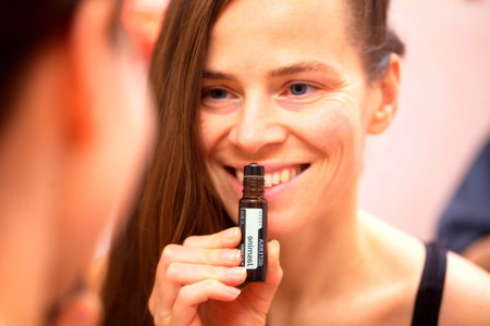 belarus, minsk, 2021. illustrative editorial doterra oil in hand womanのeditorial素材