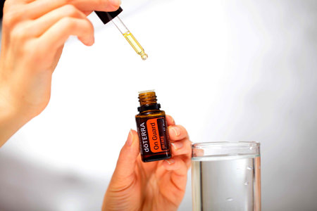 belarus, minsk, 2021. illustrative editorial doterra oil in hand womanのeditorial素材