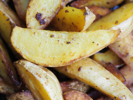 potato slices baked in butter with oregano turmeric and curryの写真素材