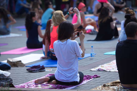 Belarus, Minsk, 2016.people doing exercise in the park during the international yoga day festivalのeditorial素材