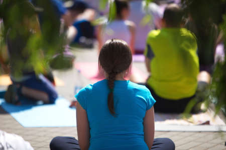 Belarus, Minsk, 2016.people doing exercise in the park during the international yoga day festivalのeditorial素材