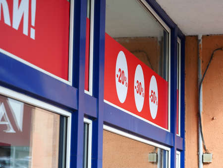 red color sale sign percent discounts on storefront