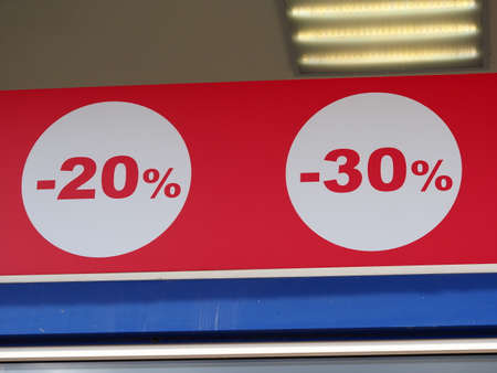 red color sale sign percent discounts on storefrontの写真素材