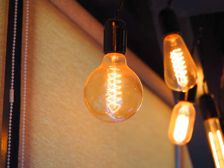 old vintage type incandescent light bulbs shine in the interior of the studio
