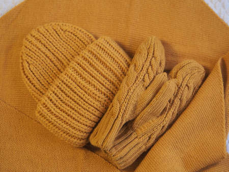 a set of warm yellow clothes. hat mittens and scarf