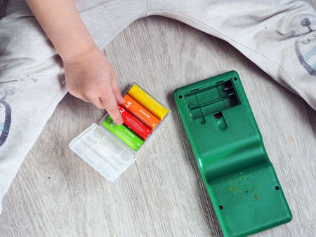 child hand paste batteries in toy