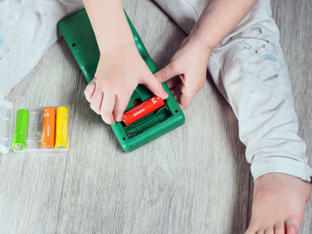 child hand paste batteries in toyの写真素材