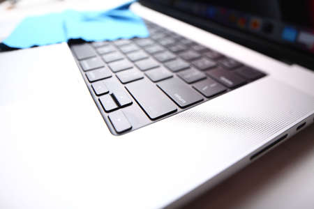 Belarus,Minsk,2022.dust stuck to the problematic keyboard of a MacBook Pro 2021 wiped with a rag by...