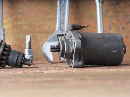 scooter starter repair parts and tools on table