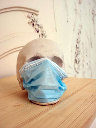 white plaster skull in a disposable maskの写真素材