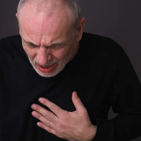 adult man with closed eyes emotion of pain on his faceの写真素材