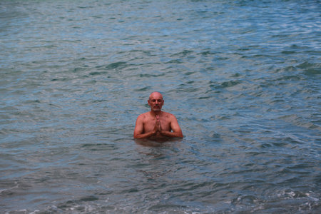 Portrait of a senior man in the sea, looking at cameraの写真素材