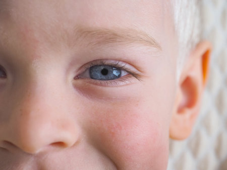 Close-up of a child's face with blue eyes. selective focus.の写真素材