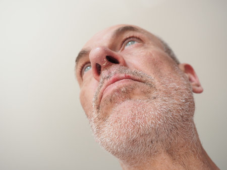 Close-up portrait of a middle-aged man with a beardの写真素材