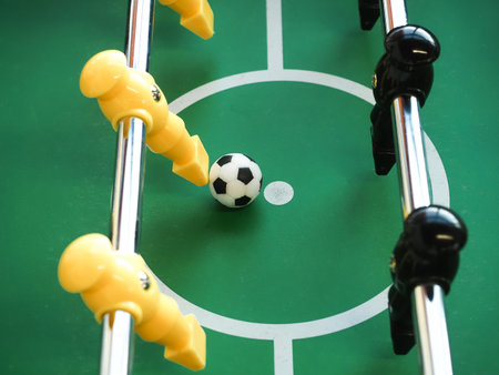Table football game with yellow and white ball. Close-up.の写真素材