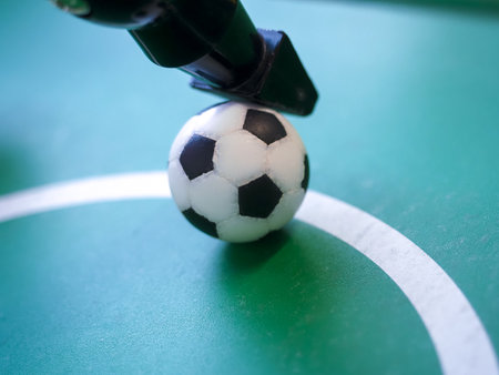 Soccer ball on a green table with a black and white background