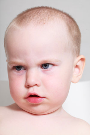 Portrait of a baby boy with blue eyes on a white backgroundの写真素材