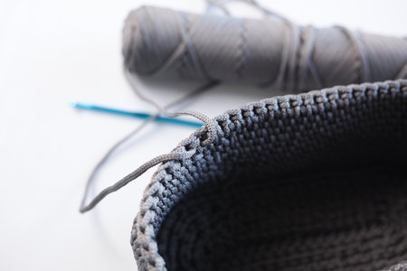 Knitting with needles and yarn on a white background. Close-up.