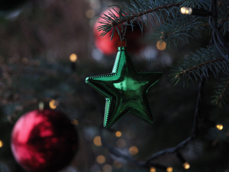 a Christmas tree decorated with balls and stars on a city streetの写真素材