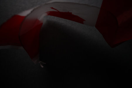 Crumpled red ribbon on a black background. Copy space.の写真素材