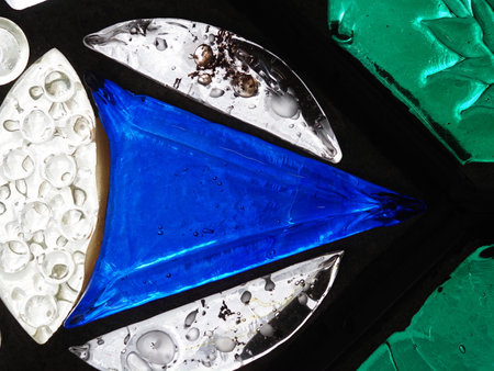 A close up view of a blue and white abstract glass composition.