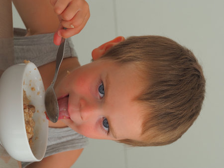 portrait blonde kid in home kitchenの写真素材