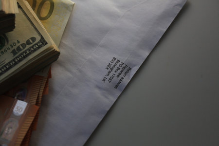 Money and envelopes on a gray background. The concept of financial security.