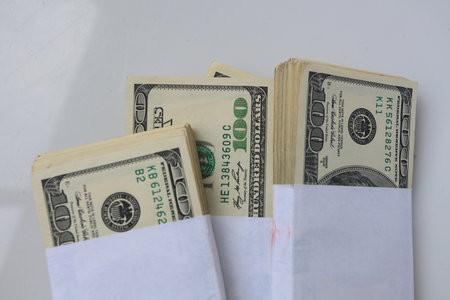 Dollars in envelope on a white background. Close-up.