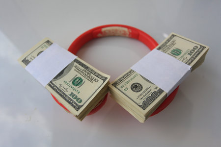 Dollars in a red bracelet on a white background, closeup of photo
