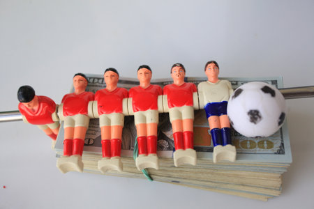 Soccer players with money on white background, closeup of photo