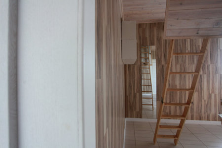Interior of a room with a wooden staircase and white wallsの写真素材