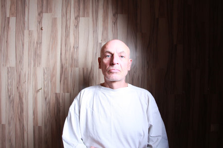 Portrait of a bald man in a white T-shirt.の写真素材