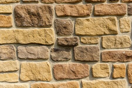 Old stone cladding plates on the wall closeupの写真素材