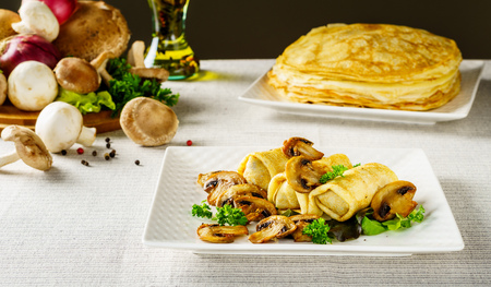 Hot Russian pancakes or blini with mushroomsの写真素材