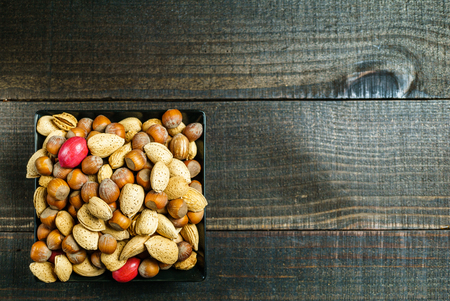 food background with variety of nuts on rustic tableの写真素材
