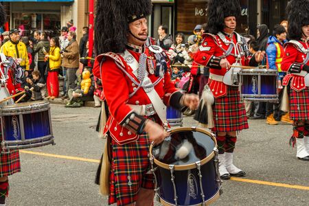 VANCOUVER, CANADA - February 2, 2014: scottish kilt Pipe band march in Chinese New Year parade in Vancouver Canadaのeditorial素材